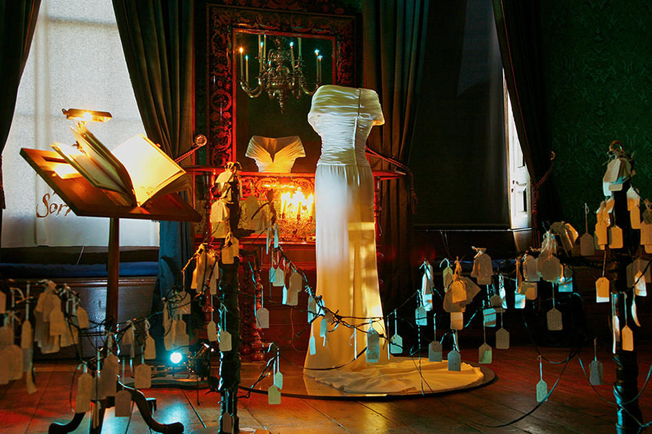 Princess Diana’s extant Bruce Oldfield gown, reflecting modern royal history inside the Room of Royal Sorrows at Kensington Palace. (Photo courtesy of Wildworks.)