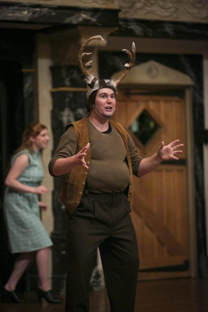 The youth actor portraying Falstaff onstage at the Blackfriars Playhouse, with Mistress Page in the background. Courtesy of the American Shakespeare Center. 2015.