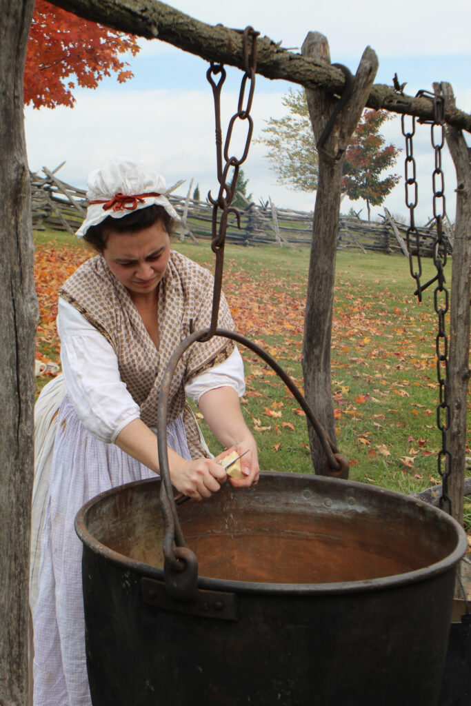 Revolutionary War reenactor demonstrating laundry work at a military camp