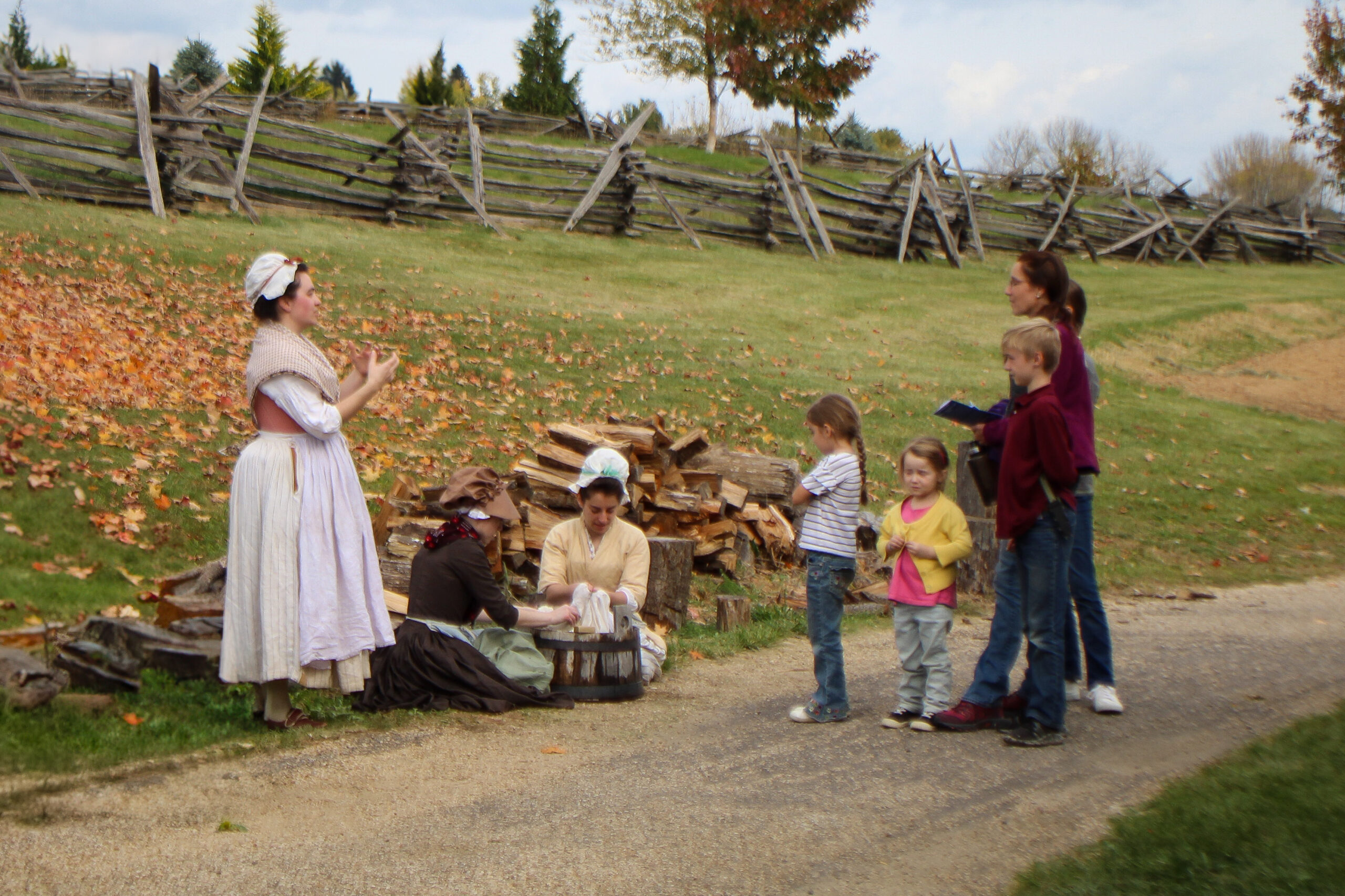Revolutionary War re-enactors demonstrating laundry work at a military camp for site visitors