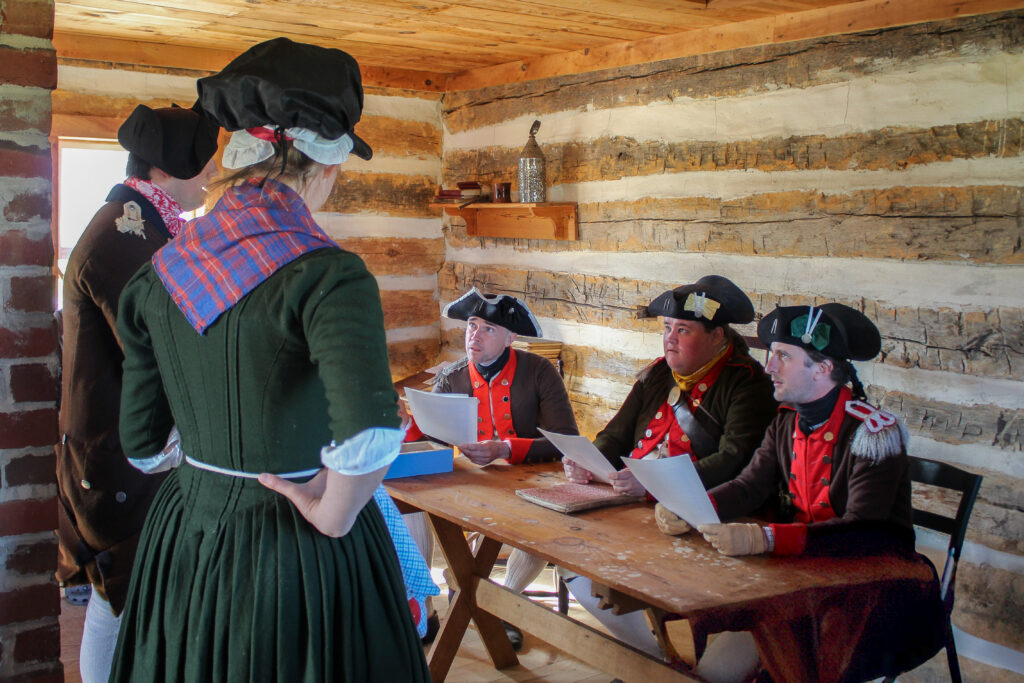 Living history court martial scene with re-enactors portraying officers of Crockett’s Western Battalion during the American Revolutionary War.
