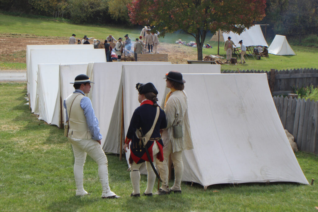 American Revolution era living history camp scene with Convention Army prisoners and officer.