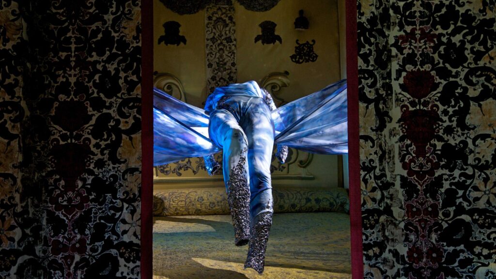The Dress of Tears suspended above Queen Mary II’s bed in the Room of Royal Sorrows. (Photo courtesy of Wildworks.)
