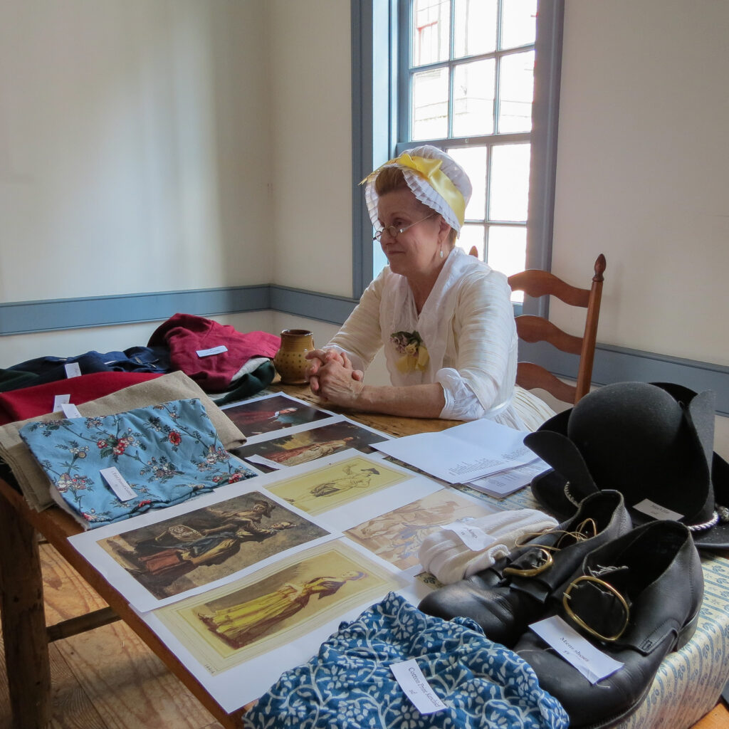 A re-enactor with experience in portraying a milliner and mantua maker explains 18th c clothing.