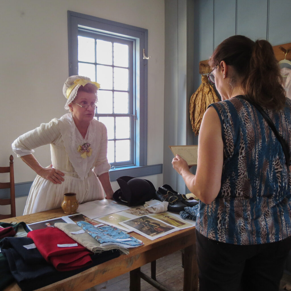 A re-enactor with experience in portraying a milliner and mantua maker explains 18th c clothing.