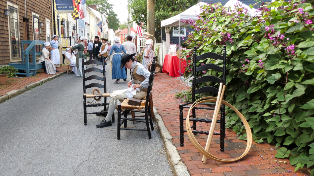 Colonial craftsman at work on Pinkney Street, reverse view.