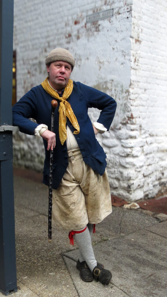 18th-century sailor on historic Wayman's Alley, dating back to Revolutionary Annapolis.