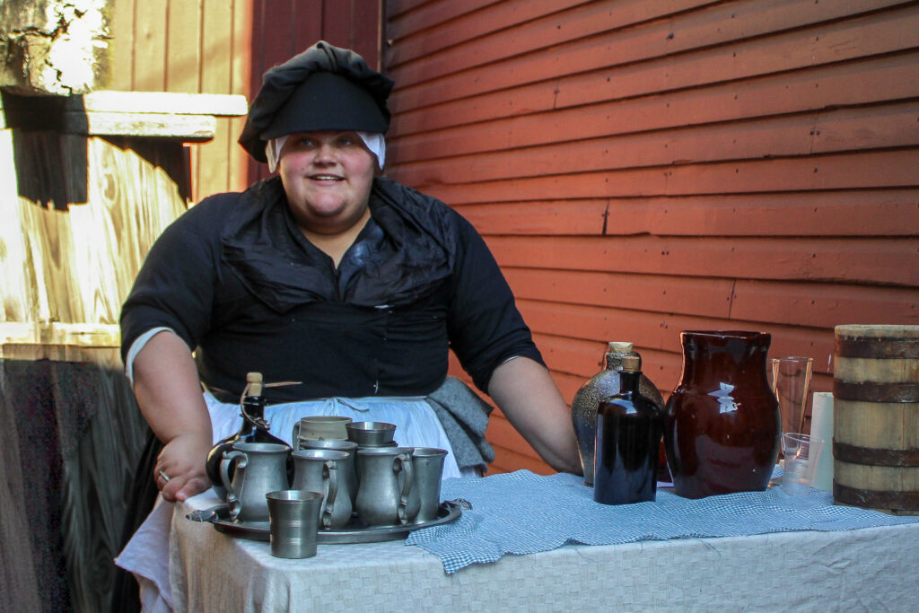 Interpreter as unlicensed tavern keeper in Revolutionary Annapolis living history event.