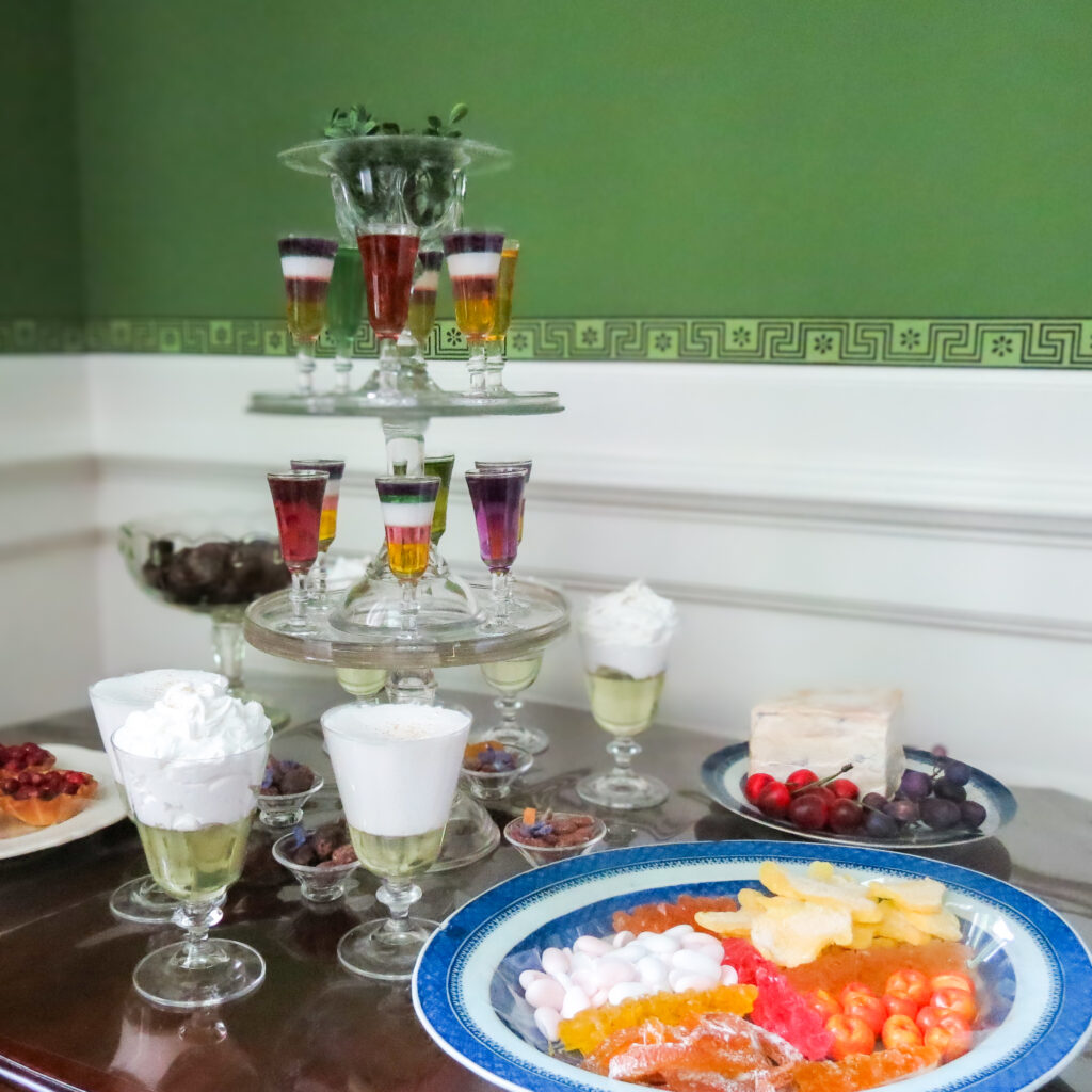 Holiday Sweets. Tiered platters display jellies, syllabub, and dainties. 2025.