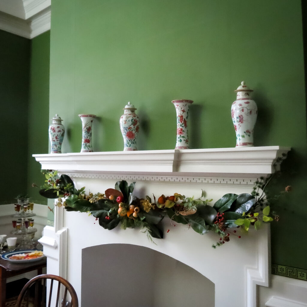 Seasonal Greenery. A garland of magnolia leaves decorates the dining room mantel. 2025.