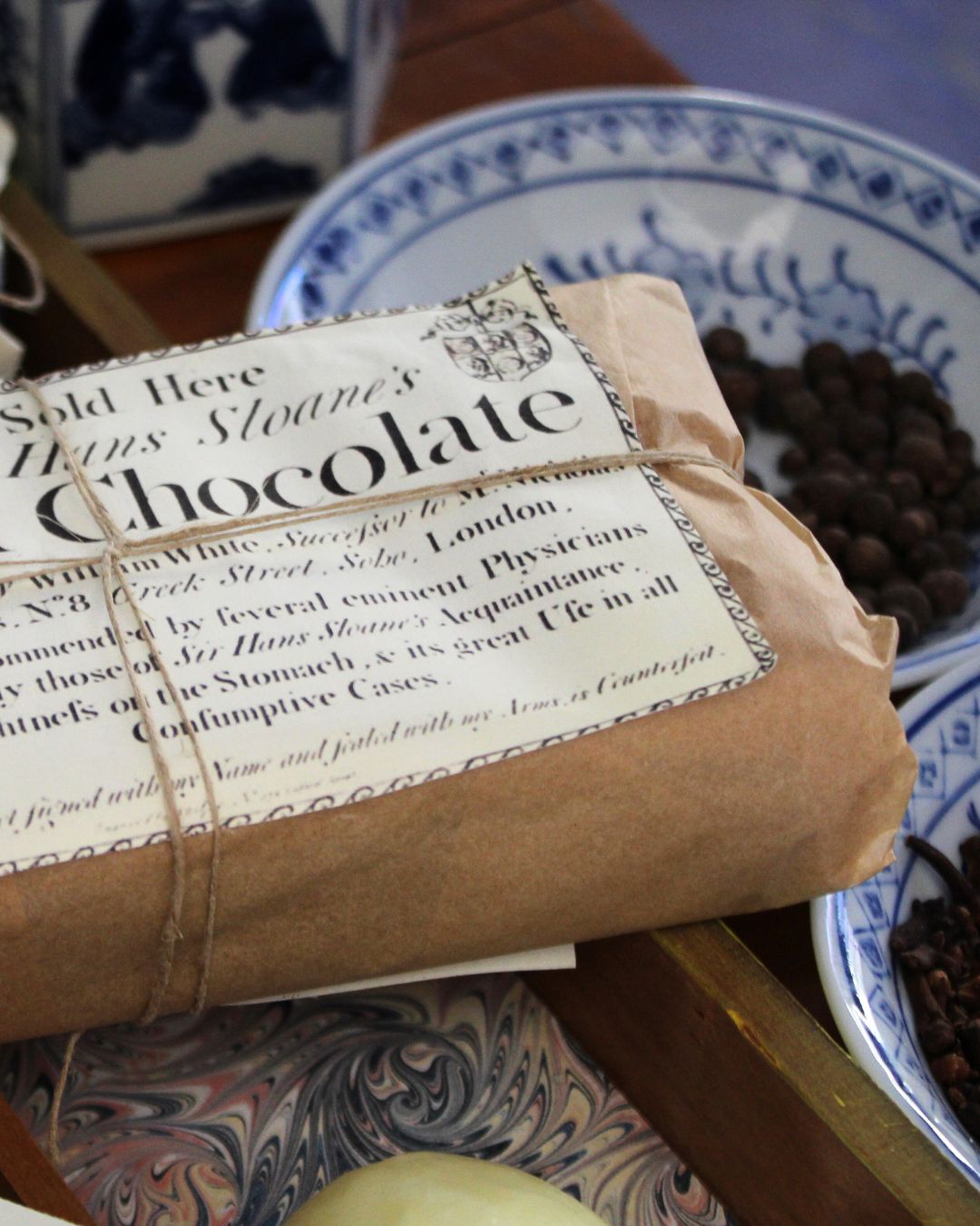 A brick of chocolate and assorted spices in an 18th-century millinery.