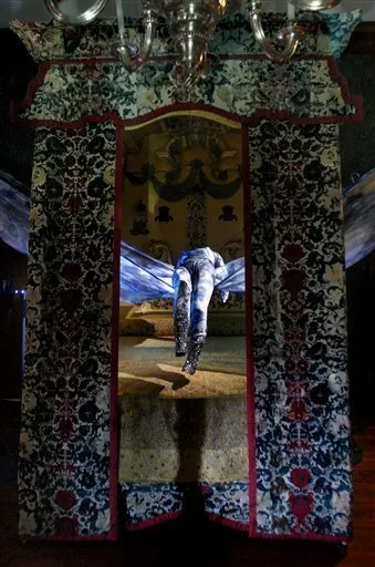 A 'dress of tears' by Aminaka Wilmont hangs above the bed in Queen Mary II's bedchamber in Kensington Palace in London, Thursday, March 25, 2010. (AP Photo/Kirsty Wigglesworth)