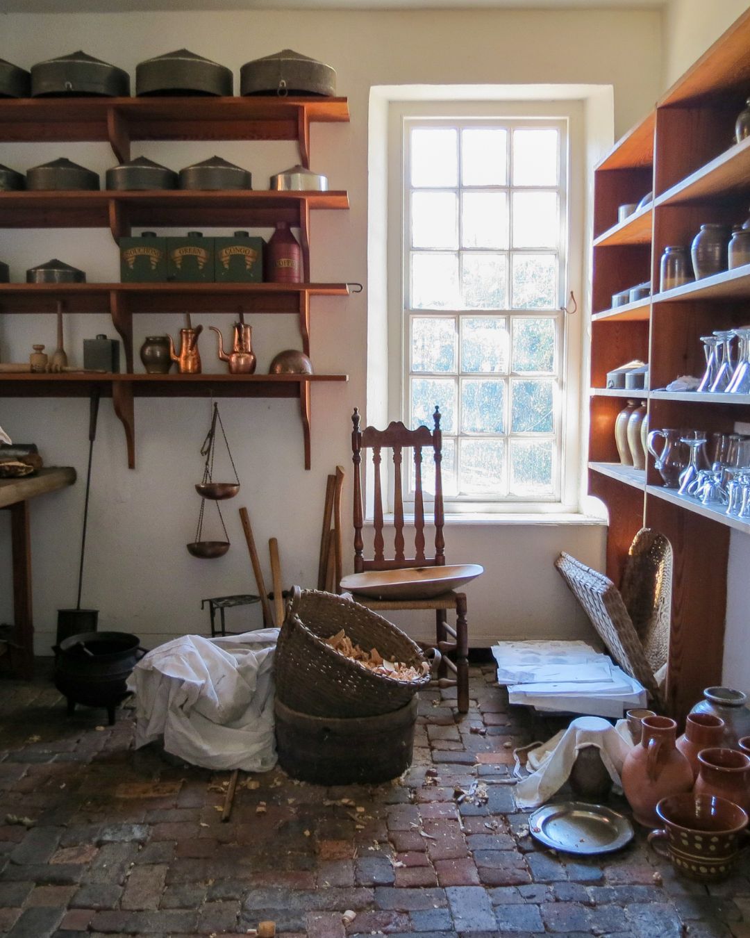 The kitchen scullery at the Governor’s Palace, Colonial Williamsburg, shown in a living history photography portrait of domestic spaces.