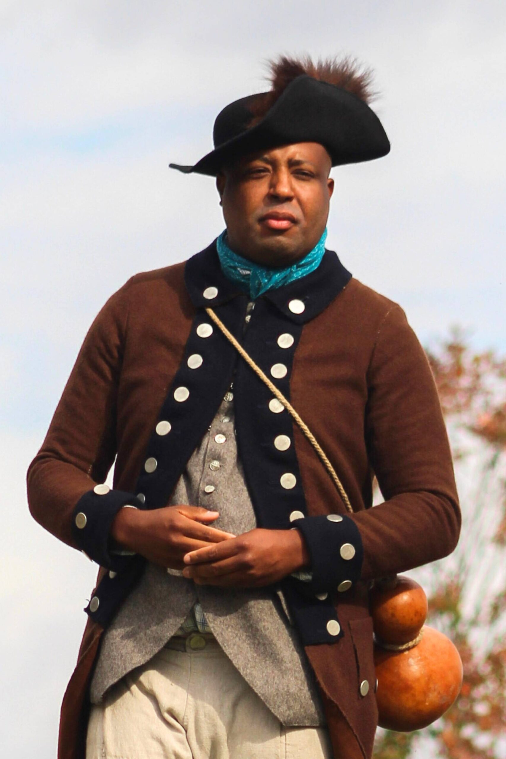 Portrait of a Black reenactor wearing an 18th-century Continental military uniform.