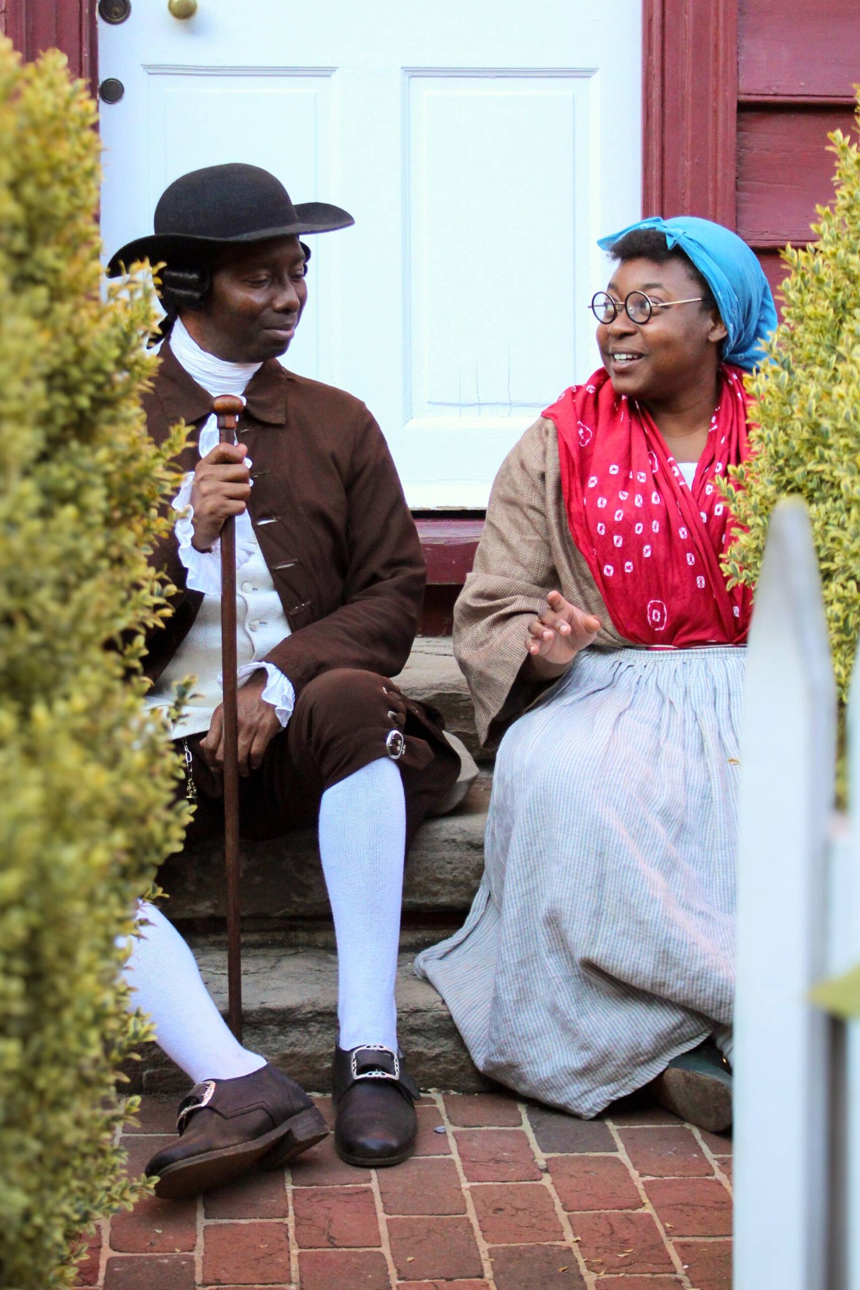 Living history photography depicting two reenactors representing free Black community members in the 18th century.