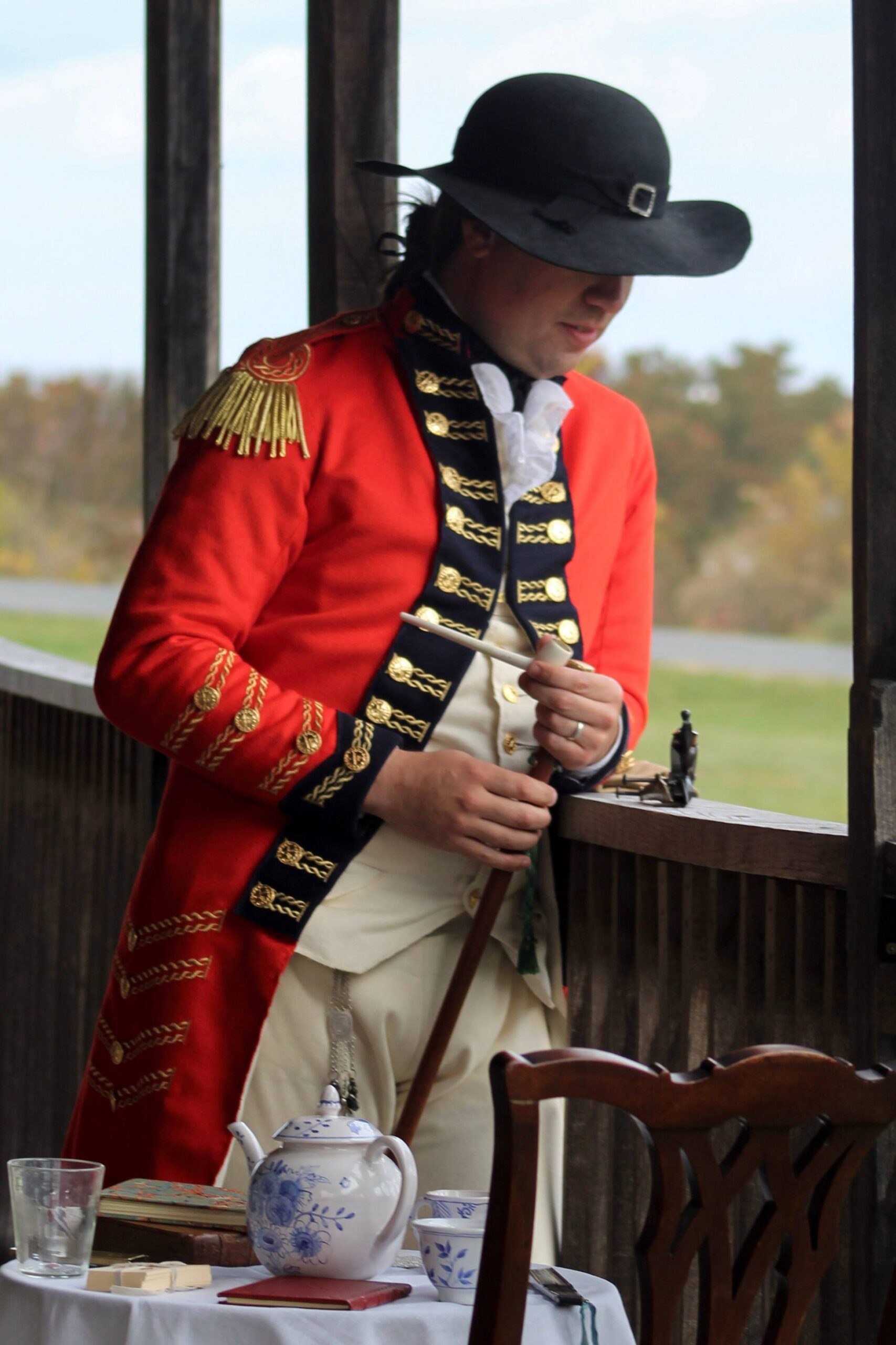 Portrait of a living history reenactor dressed as an 18th-century military officer, captured with careful attention to historical detail.