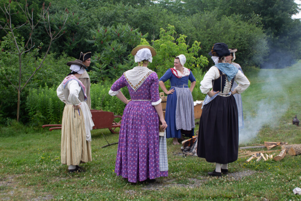 Camp followers chatting outside the walls of Fort Ticonderoga, Ticonderoga, New York. 2026.